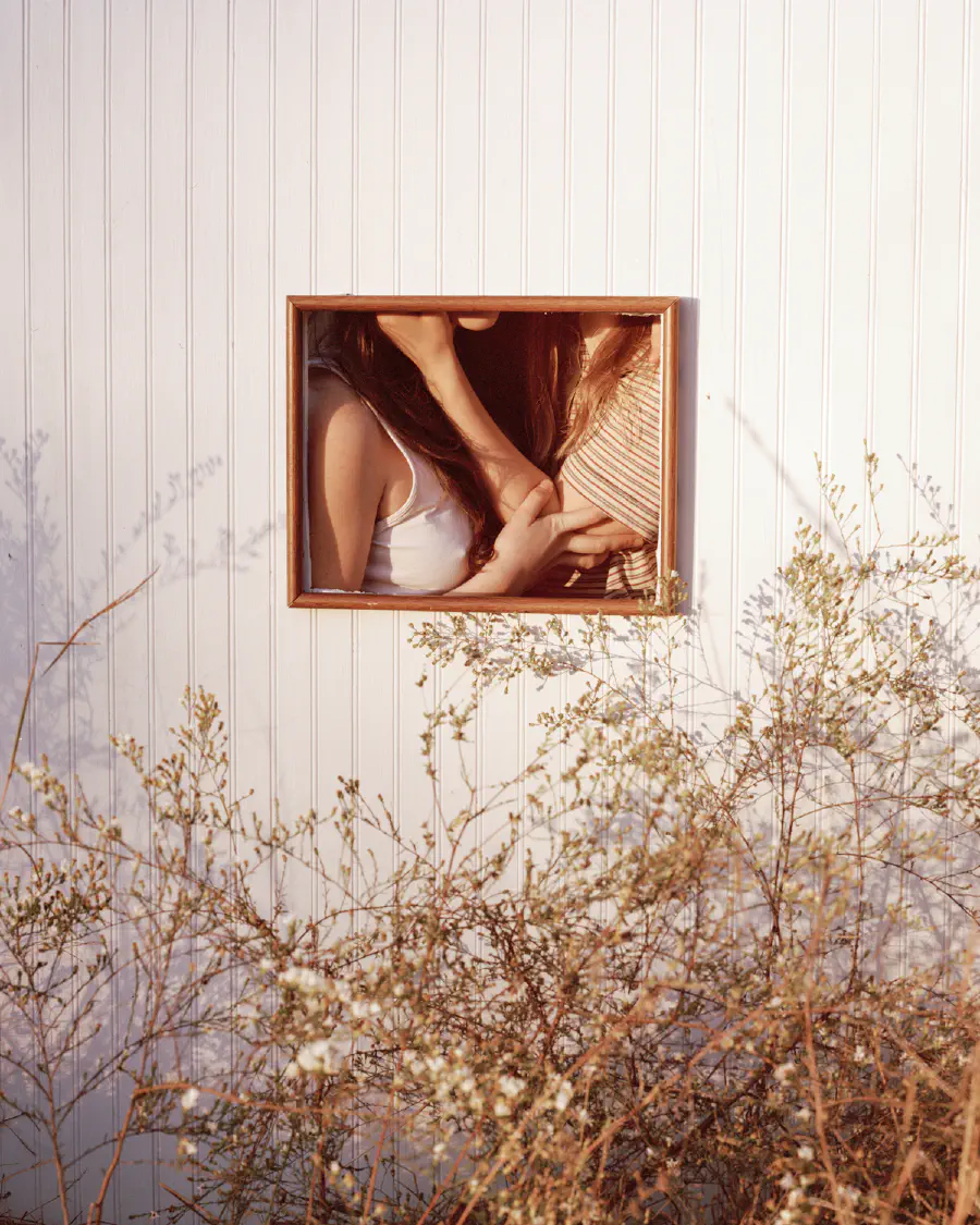 Two people kissing out of frame.