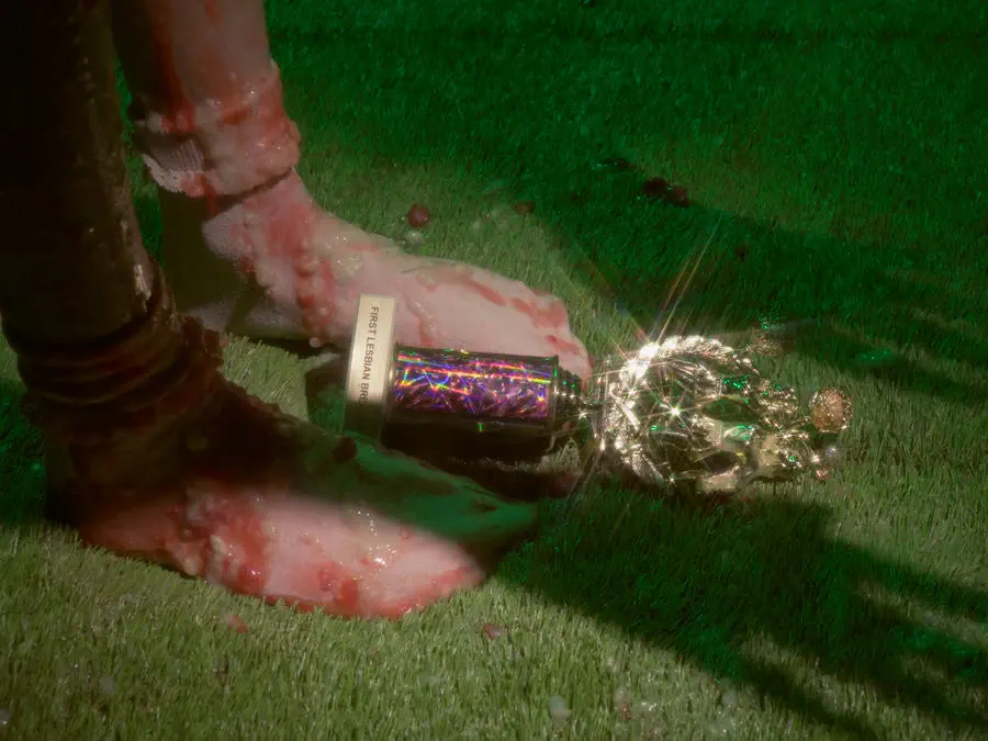 Two feet kicking at a trophy, covered in some sort of goop.