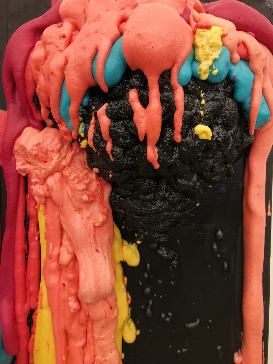 A close-up of the monument with pink 'hair' and slightly blue 'bangs.'