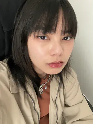 A photo of a person with dark hair looking at the camera.